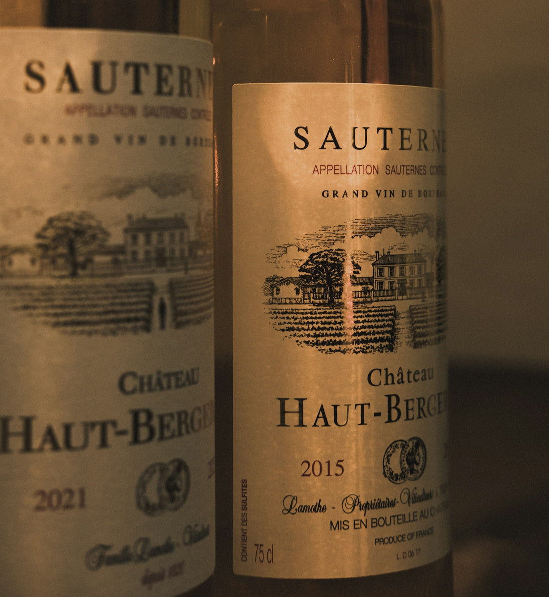 two bottles of wine sitting next to each other