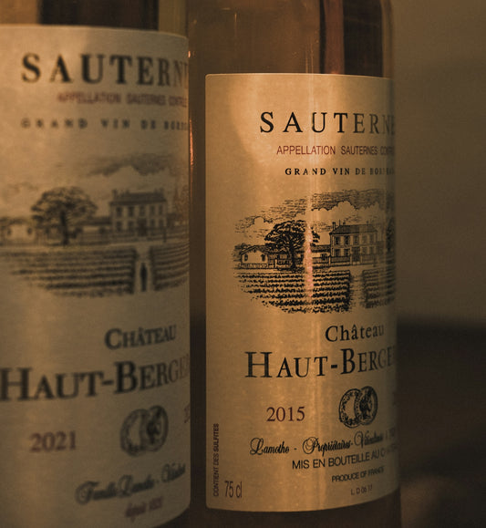 two bottles of wine sitting next to each other