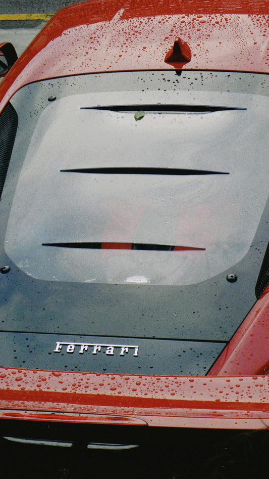 A red sports car parked in a parking lot